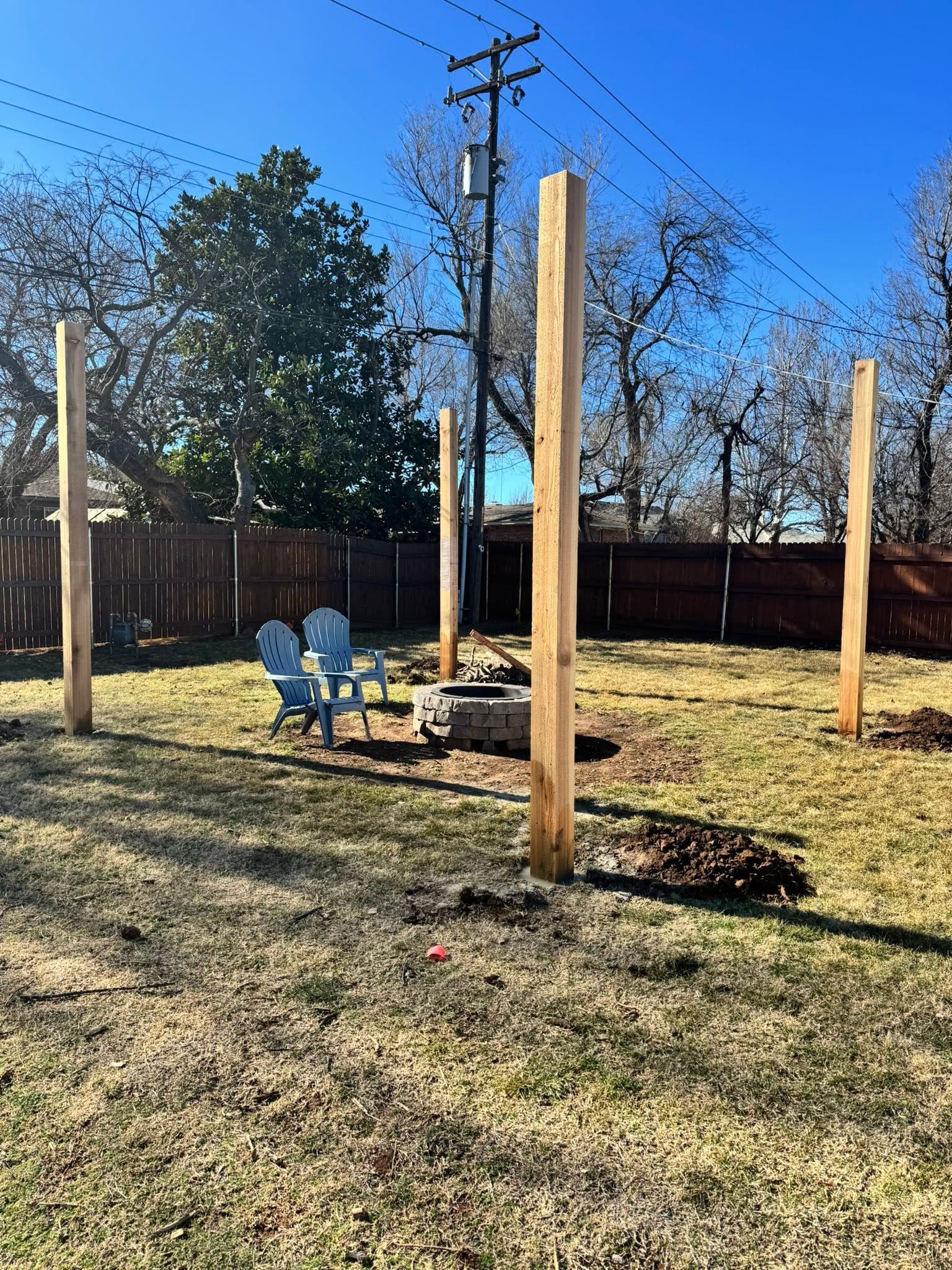 Wood posts set in a backyard framing project
