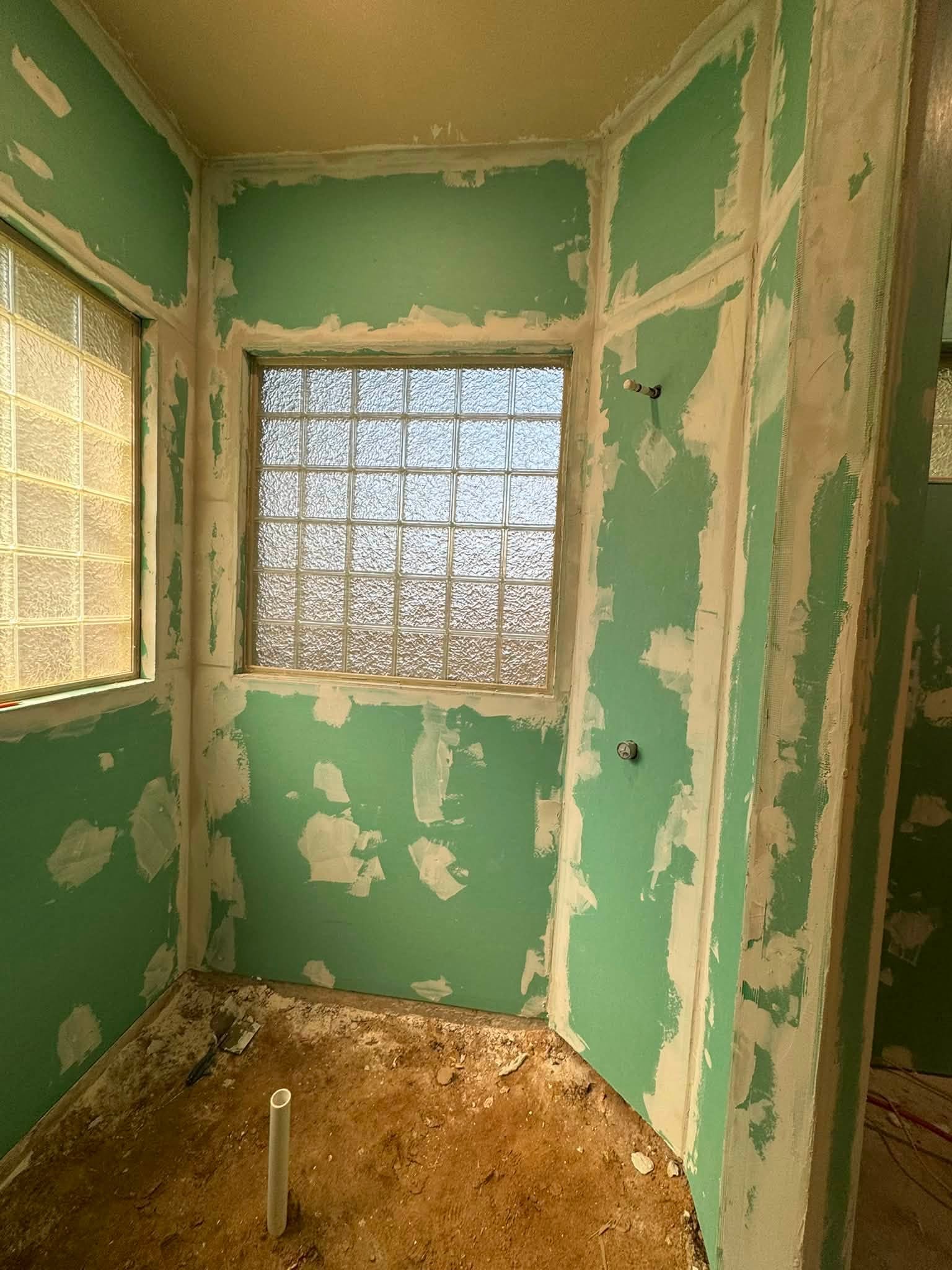 Taped greenboard drywall inside a shower enclosure