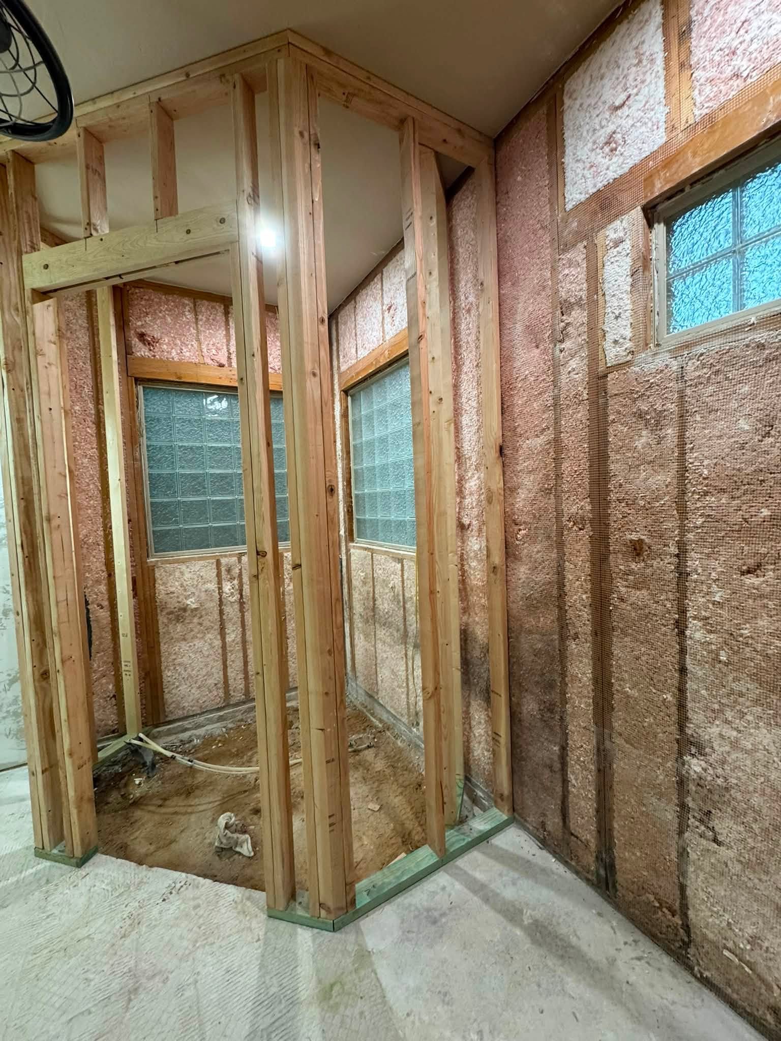 Interior stud wall framed in front of insulated exterior walls