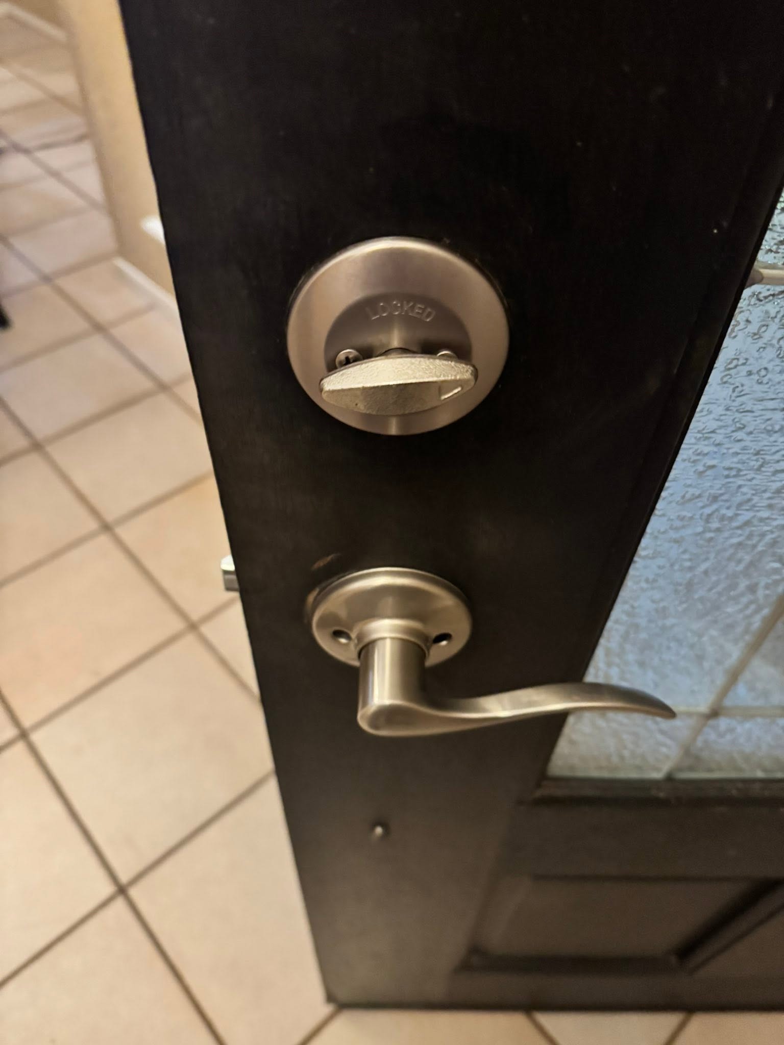 Door lock and lever handle installed on an entry door